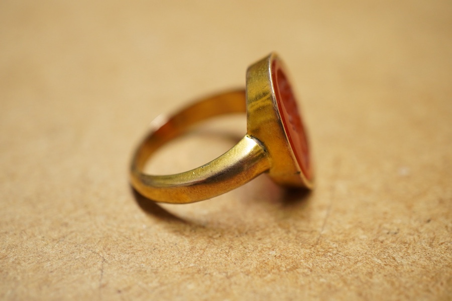 A yellow metal and intaglio carnelian set ring, the matrix carved with the bust of a gentleman to sinister, gross weigh 5.2 grams.